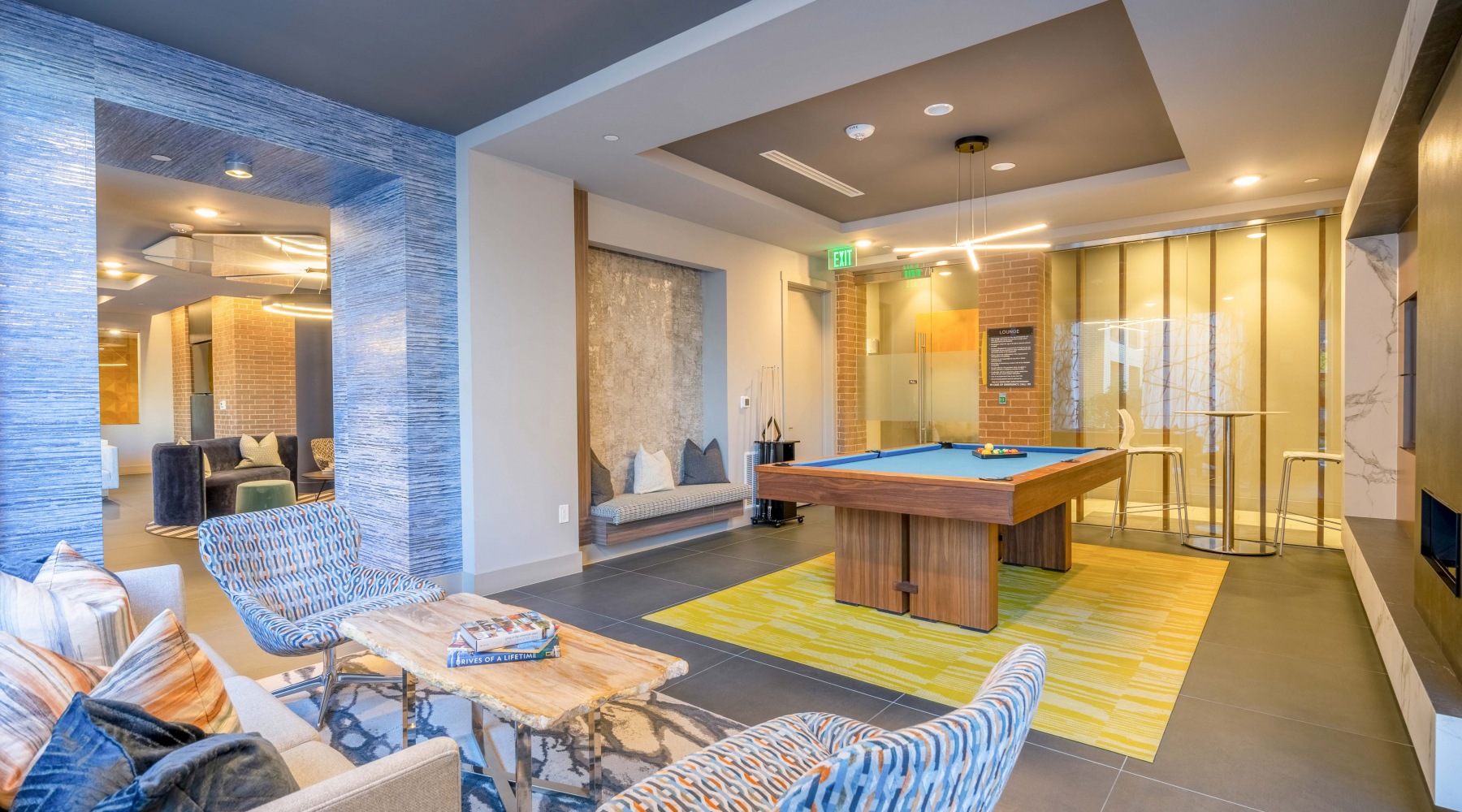 Welcome Home Resident lounge and entertainment room at our apartments for rent in Frisco, featuring a billiards table and chairs.