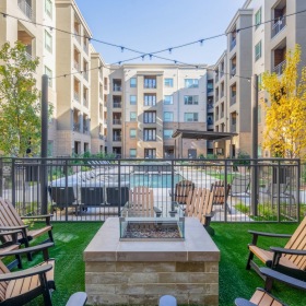 Welcome Home Outdoor lounge at Cadence at Frisco Station apartments in Frisco, TX, featuring outdoor seating and a fire pit.