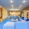 A community lounge furnished a large blue sectional sofa and a communal dining space at apartments in Frisco Station.