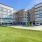 The exterior of the Cadence at Frisco Station Apartments in Frisco, TX, featuring a view of the parking lot and entrance.
